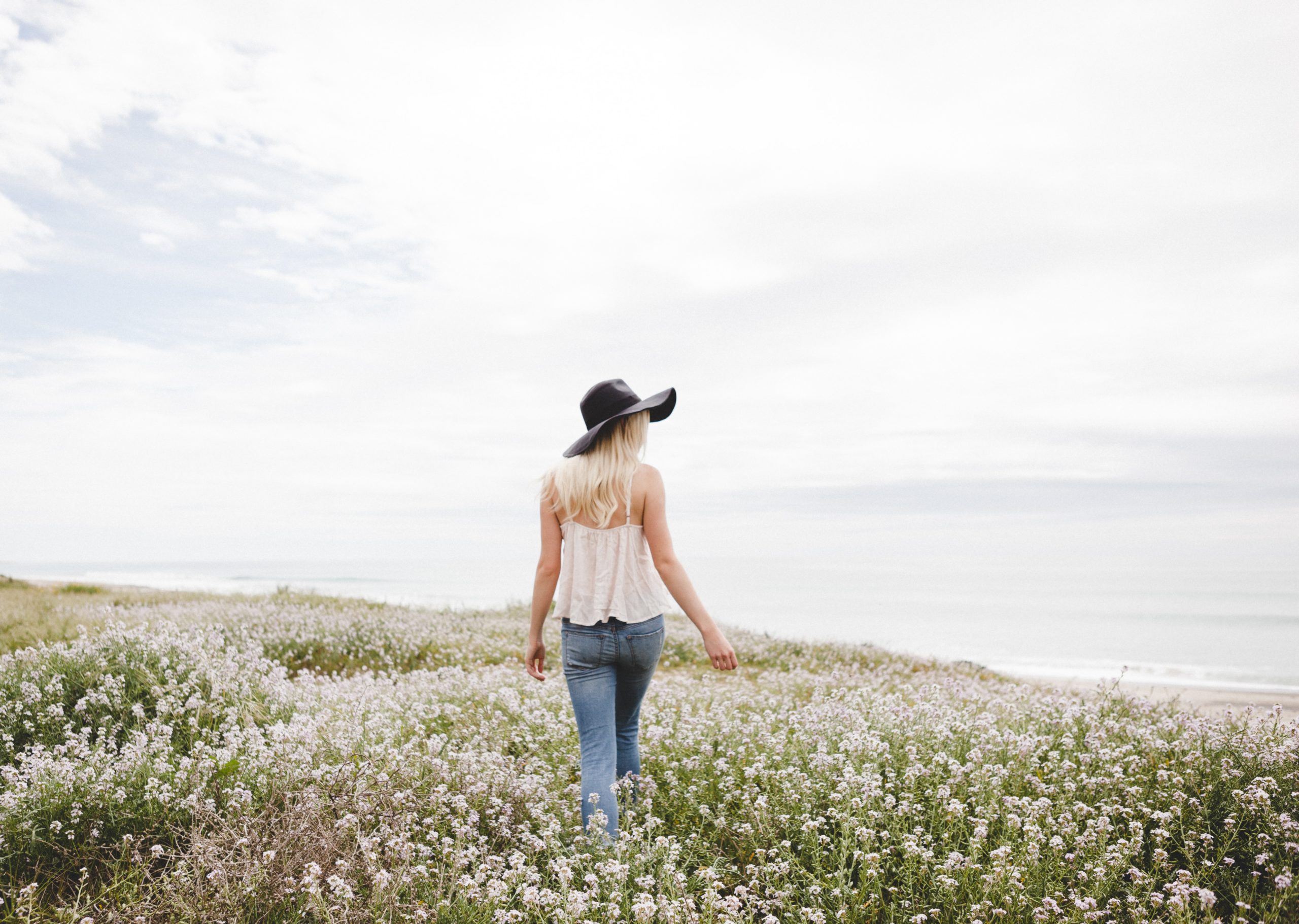 Women walking in a field of flowers